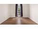 Bedroom featuring wood-look floors and a large window providing natural light at 625 Chaseridge Dr, Mcdonough, GA 30253