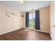Bedroom featuring wood-look floors and a large window providing natural light at 625 Chaseridge Dr, Mcdonough, GA 30253