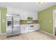 Bright kitchen with stainless steel refrigerator, white cabinets, and ample counter space at 625 Chaseridge Dr, Mcdonough, GA 30253