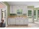 Traditional-style kitchen with white cabinets, double sink, and bright natural lighting at 625 Chaseridge Dr, Mcdonough, GA 30253