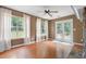 Spacious living room featuring hardwood floors and natural light from the surrounding windows at 625 Chaseridge Dr, Mcdonough, GA 30253