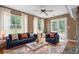 Bright living room with large windows, fireplace, and comfortable seating, virtually staged at 625 Chaseridge Dr, Mcdonough, GA 30253
