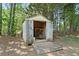 A weathered shed with open doors reveals storage space and a ramp for easy access in backyard at 625 Chaseridge Dr, Mcdonough, GA 30253