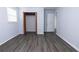 Bright bedroom featuring hardwood floors, closet, and adjoining door at 1112 Mealor Rd, Lawrenceville, GA 30043
