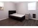 Bedroom with hardwood floors, neutral walls, natural light, and simple furnishing at 1112 Mealor Rd, Lawrenceville, GA 30043