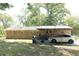 Back of brick home with a convenient carport, outdoor grill, and spacious backyard at 1112 Mealor Rd, Lawrenceville, GA 30043
