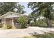 Charming exterior view of brick home with porch, driveway and mature trees at 1112 Mealor Rd, Lawrenceville, GA 30043