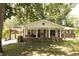 Charming single-story brick home with a covered front porch and a well-maintained lawn at 1112 Mealor Rd, Lawrenceville, GA 30043