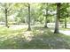 Large front yard with mature trees, green grass and long driveway at 1112 Mealor Rd, Lawrenceville, GA 30043