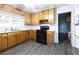 Functional kitchen featuring durable laminate countertops, wood cabinets and black appliances at 1112 Mealor Rd, Lawrenceville, GA 30043
