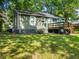 Backyard view with lush lawn, a deck with steps, and shade trees at 1560 Pontiac Se Pl, Atlanta, GA 30315