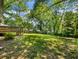 Wide backyard with lush green grass, mature trees, and a deck at 1560 Pontiac Se Pl, Atlanta, GA 30315