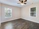 Bedroom features wood flooring and natural light from the two windows at 1560 Pontiac Se Pl, Atlanta, GA 30315
