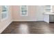 Open dining room with two windows and a door to the kitchen boasting new floors at 1560 Pontiac Se Pl, Atlanta, GA 30315