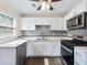 Modern kitchen with stainless steel appliances, white cabinets, and stylish subway tile backsplash at 1560 Pontiac Se Pl, Atlanta, GA 30315