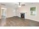 Bright living room with a decorative fireplace, new flooring, and a ceiling fan for added comfort at 1560 Pontiac Se Pl, Atlanta, GA 30315