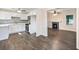 Open-concept space showcasing the modern kitchen and living room with decorative fireplace at 1560 Pontiac Se Pl, Atlanta, GA 30315