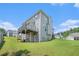 Back exterior of house with walkout basement and grassy sloping backyard at 201 Providence Dr, Dallas, GA 30157