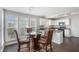 Bright dining area with a glass table and windows overlooking the backyard and leading into the kitchen at 201 Providence Dr, Dallas, GA 30157