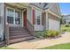 Inviting front porch with wood railings and steps, showcasing a charming entrance to the home at 201 Providence Dr, Dallas, GA 30157