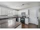 Well-lit kitchen features white cabinets, laminate countertops, and stainless steel appliances at 201 Providence Dr, Dallas, GA 30157
