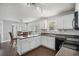 Open concept kitchen with dark countertops and a breakfast bar perfect for entertaining guests at 201 Providence Dr, Dallas, GA 30157
