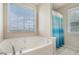 Relaxing main bathroom with soaking tub, shower curtain and large windows at 201 Providence Dr, Dallas, GA 30157