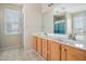 Bright main bathroom featuring dual sinks, wood cabinets and a large window at 201 Providence Dr, Dallas, GA 30157