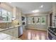 Bright kitchen showcasing white cabinets, granite countertops, and hardwood floors at 3916 S Martin Way, Lithia Springs, GA 30122