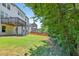Spacious backyard with a well-maintained lawn, wooden deck, and privacy fence offering a serene outdoor space at 5740 Zelkova Dr, Cumming, GA 30040