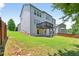Exterior backyard view of the home with a lawn, fence, and two-story deck at 5740 Zelkova Dr, Cumming, GA 30040