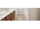 Bathroom featuring a dual sink vanity with tile flooring and a large bathtub at 5740 Zelkova Dr, Cumming, GA 30040