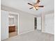 Bedroom showing ensuite bathroom, closet, a ceiling fan with lights, and carpet at 5740 Zelkova Dr, Cumming, GA 30040