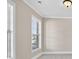 Bright bedroom featuring neutral paint, large windows, and plush carpet at 5740 Zelkova Dr, Cumming, GA 30040