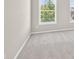 Bright bedroom with natural light from two windows, soft carpet, and neutral walls at 5740 Zelkova Dr, Cumming, GA 30040
