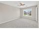 Bright bedroom with carpet, a ceiling fan with lights, and a window overlooking the yard at 5740 Zelkova Dr, Cumming, GA 30040