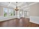 Stylish dining room with hardwood floors, chandelier, and a coffered ceiling at 5740 Zelkova Dr, Cumming, GA 30040