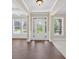 Bright foyer featuring hardwood floors, transom windows, and classic millwork at 5740 Zelkova Dr, Cumming, GA 30040