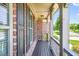 Inviting covered front porch featuring wood decking and decorative railing at 5740 Zelkova Dr, Cumming, GA 30040