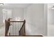 Second story hallway showcasing wood railings and a view to the rooms and stairs below at 5740 Zelkova Dr, Cumming, GA 30040