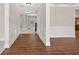 Elegant hallway features hardwood floors, wainscoting, and neutral paint at 5740 Zelkova Dr, Cumming, GA 30040