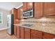 Close-up of a kitchen area featuring stainless steel appliances and granite countertops at 5740 Zelkova Dr, Cumming, GA 30040