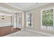 Cozy living room with hardwood floors, large windows, and classic wainscoting at 5740 Zelkova Dr, Cumming, GA 30040
