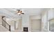 Bright living room featuring a fireplace, ceiling fan, and large windows that let in plenty of light at 5740 Zelkova Dr, Cumming, GA 30040