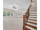Inviting living area featuring a staircase and several windows that fill the space with natural light at 5740 Zelkova Dr, Cumming, GA 30040