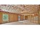 Spacious unfinished basement showing exposed framing, insulation, and a door to the outside at 5740 Zelkova Dr, Cumming, GA 30040