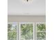 Image of three bright windows with closed blinds looking out into nature at 5740 Zelkova Dr, Cumming, GA 30040