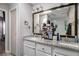 Bright bathroom with double vanity featuring granite countertop, a large framed mirror, and neutral-toned wall at 1221 Overton Dr, Lawrenceville, GA 30044