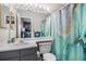 Inviting bathroom with a decorative shower curtain, vanity with sink, and ample lighting at 1221 Overton Dr, Lawrenceville, GA 30044
