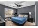 Cozy bedroom with a ceiling fan, large windows, and a stylish desk area at 1221 Overton Dr, Lawrenceville, GA 30044